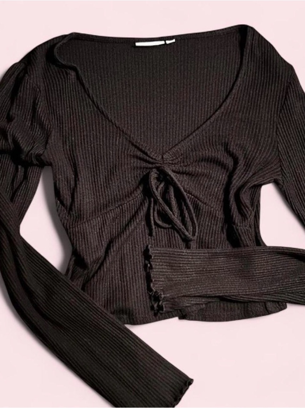 black long-sleeve top with tie / bow detail